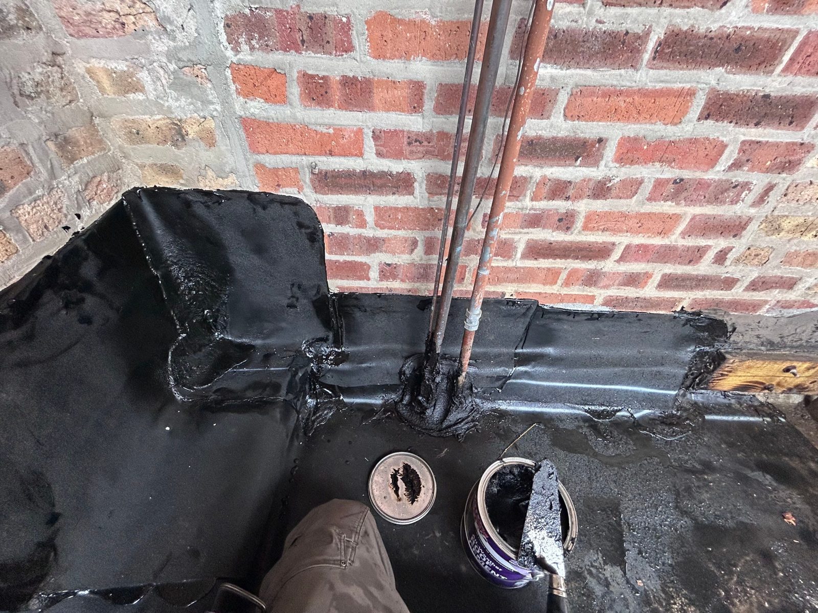 Waterproofing sealant at brick-to-slab transition.