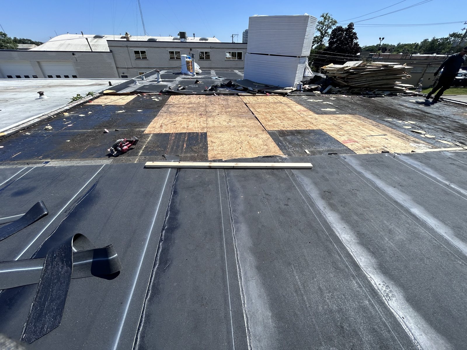 Black cap sheet over deck and cover board on a Chicago flat roof.