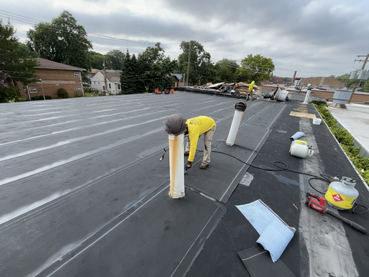 Modified bitumen install with torch gear on a Chicago flat roof.